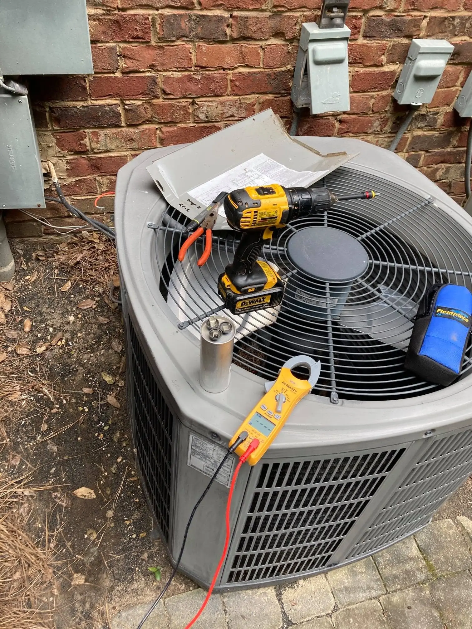 Our technician servicing an outdoor AC unit at an apartment complex in Bessemer